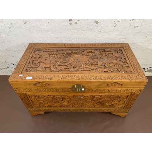 179 - A Chinese carved camphor wood blanket box - approx. 58cm high x 100cm wide x 50cm deep