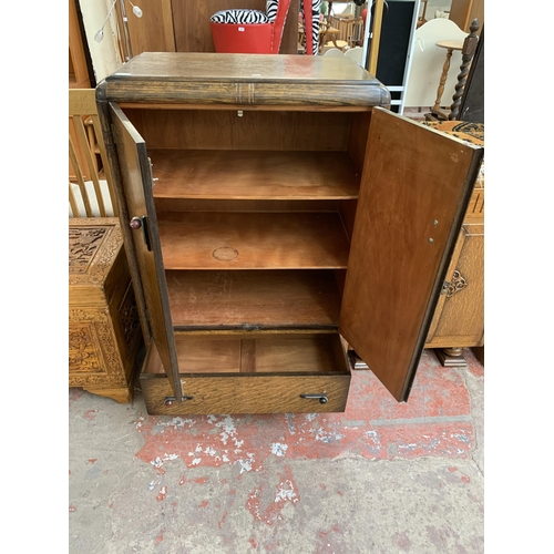 181 - An Art Deco oak two door cabinet - approx. 122cm high x 79cm wide x 48cm deep