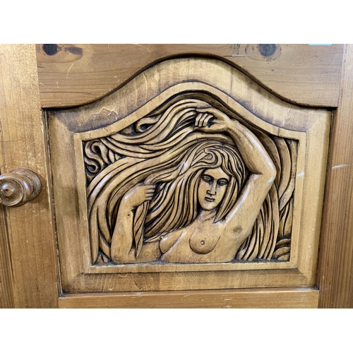 184 - A carved pine two door cabinet - approx. 110cm high x 94cm wide x 40cm deep