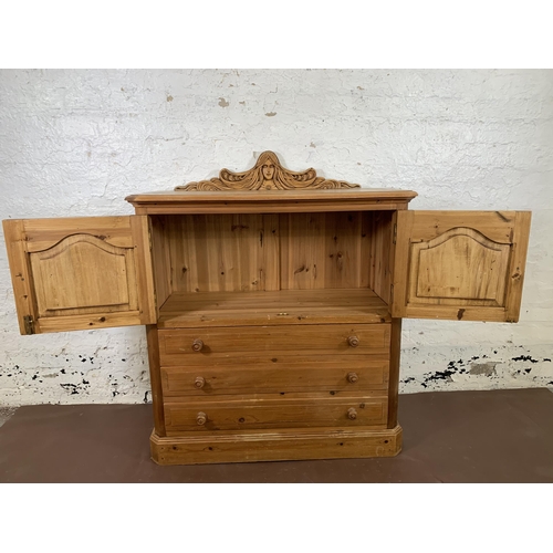 184 - A carved pine two door cabinet - approx. 110cm high x 94cm wide x 40cm deep