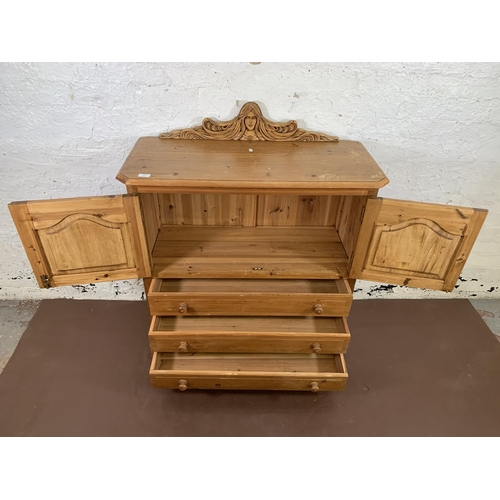 184 - A carved pine two door cabinet - approx. 110cm high x 94cm wide x 40cm deep