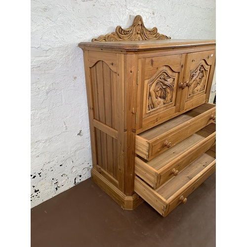 184 - A carved pine two door cabinet - approx. 110cm high x 94cm wide x 40cm deep