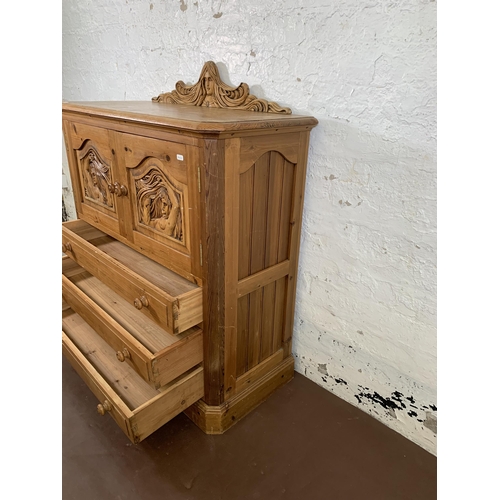 184 - A carved pine two door cabinet - approx. 110cm high x 94cm wide x 40cm deep