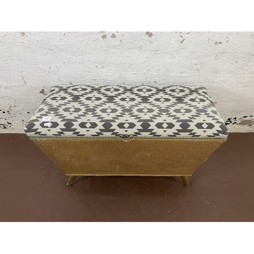 186 - An early/mid 20th century Lloyd Loom ottoman with fabric upholstered top - approx. 55cm high x 93cm ... 