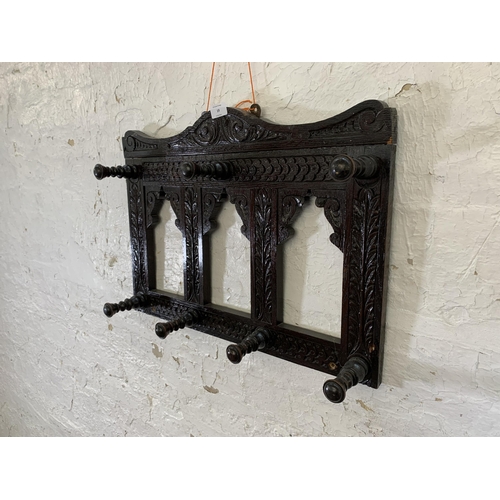 19 - A Victorian Gothic Revival style carved oak wall hanging seven hook coat rack - approx. 44cm high x ... 