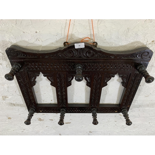 19 - A Victorian Gothic Revival style carved oak wall hanging seven hook coat rack - approx. 44cm high x ... 