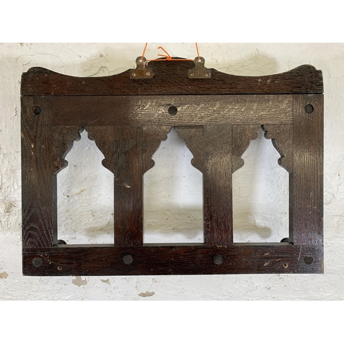 19 - A Victorian Gothic Revival style carved oak wall hanging seven hook coat rack - approx. 44cm high x ... 