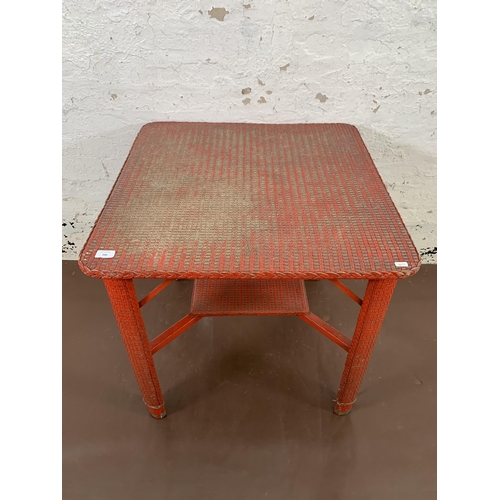 200 - A mid 20th century Lloyd Loom red painted square occasional table - approx. 69cm high x 70cm square