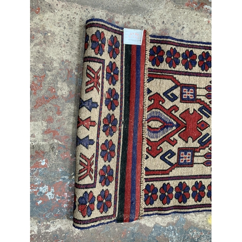 209 - A hand knotted 100% wool pile rug - approx. 125cm x 79cm