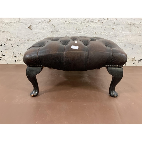 21 - A brown leather Chesterfield footstool on cabriole supports - approx. 30cm high x 60cm wide x 60cm d... 