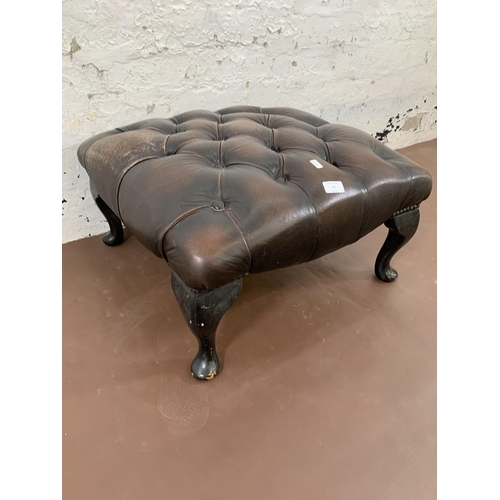 21 - A brown leather Chesterfield footstool on cabriole supports - approx. 30cm high x 60cm wide x 60cm d... 