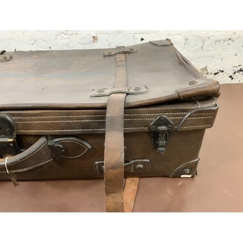 212 - An early 20th century brown leather travel trunk - approx. 26cm high x 86cm wide x 48cm deep