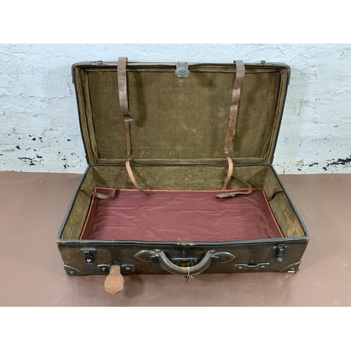 212 - An early 20th century brown leather travel trunk - approx. 26cm high x 86cm wide x 48cm deep