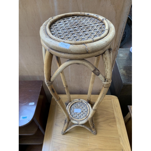 213A - A bamboo and rattan circular two tier jardinière stand - approx. 61cm high x 20cm diameter