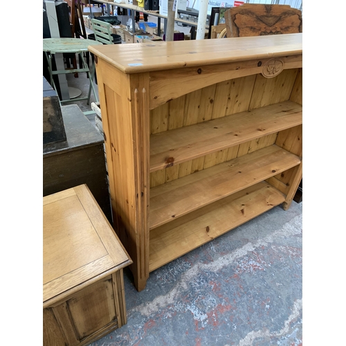 214 - A Victorian style carved pine three tier bookcase - approx. 112cm high x 125cm wide x 30cm deep