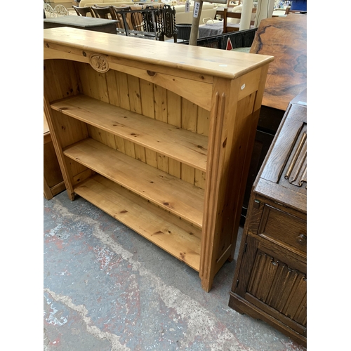 214 - A Victorian style carved pine three tier bookcase - approx. 112cm high x 125cm wide x 30cm deep