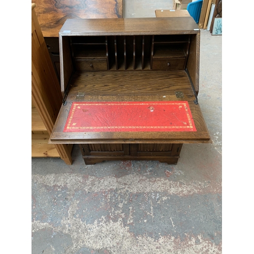 215 - A carved oak linenfold bureau - approx. 100cm high x 76cm wide x 41cm deep