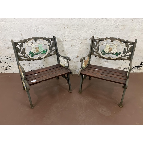 227 - A pair of cast iron and wooden slatted child's garden armchairs