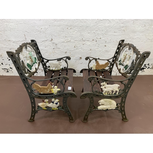 227 - A pair of cast iron and wooden slatted child's garden armchairs