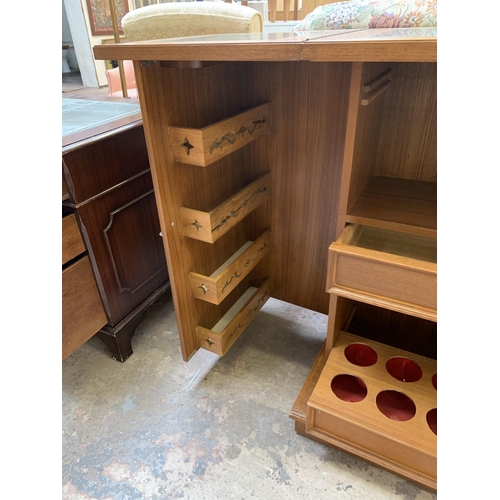 23 - A mid 20th century teak and burr walnut effect metamorphic cocktail cabinet/bar with marble inlay - ... 