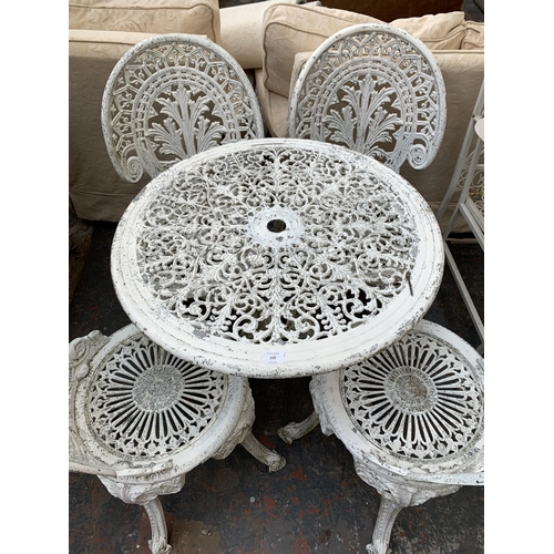 230 - A Victorian style white painted cast metal five piece patio set comprising circular table and four c... 