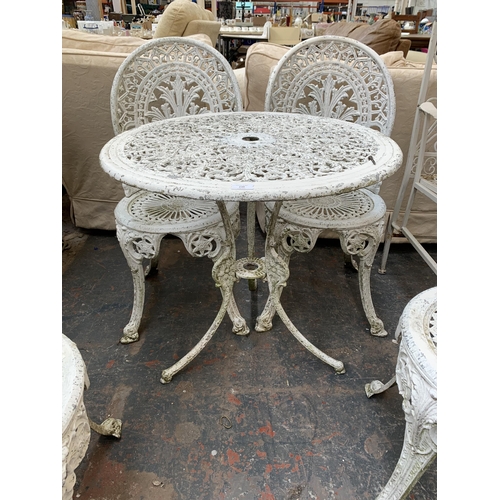 230 - A Victorian style white painted cast metal five piece patio set comprising circular table and four c... 