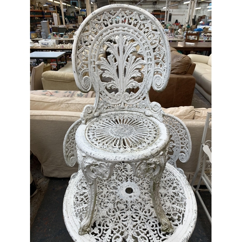 230 - A Victorian style white painted cast metal five piece patio set comprising circular table and four c... 