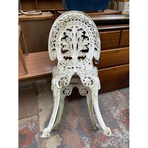 230 - A Victorian style white painted cast metal five piece patio set comprising circular table and four c... 