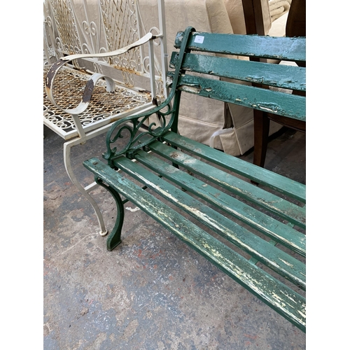 233 - A Victorian style green painted cast metal and wooden slatted two seater garden bench - approx. 122c... 