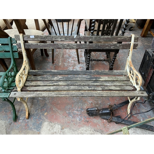 235 - A Victorian style cast metal and wooden slatted two seater garden bench - approx. 122cm wide