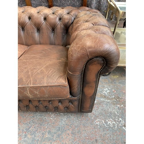 239 - A brown leather Chesterfield three seater sofa