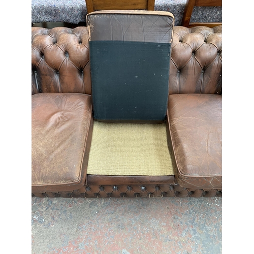 239 - A brown leather Chesterfield three seater sofa