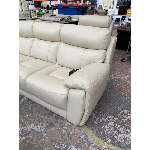 247 - A modern cream leather two piece lounge suite comprising three seater sofa and armchair