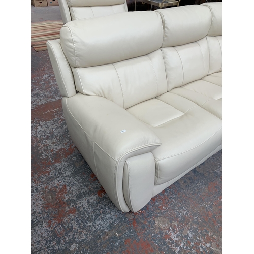 247 - A modern cream leather two piece lounge suite comprising three seater sofa and armchair