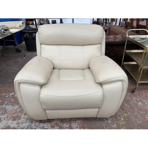 247 - A modern cream leather two piece lounge suite comprising three seater sofa and armchair