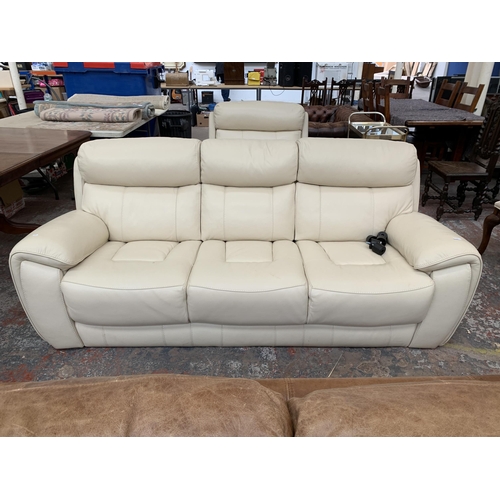 247 - A modern cream leather two piece lounge suite comprising three seater sofa and armchair