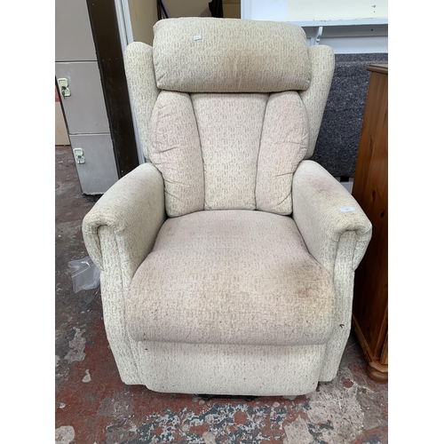 42 - A modern fabric upholstered electric rise and recline armchair with remote and power supply