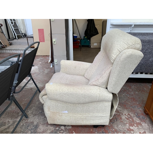 42 - A modern fabric upholstered electric rise and recline armchair with remote and power supply