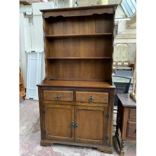 46 - A carved oak dresser - approx. 175cm high x 94cm wide x 40cm deep