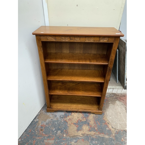 48 - A carved oak bookcase - approx. 112cm high x 80cm wide x 30cm deep