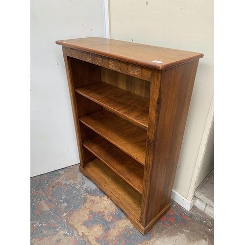 48 - A carved oak bookcase - approx. 112cm high x 80cm wide x 30cm deep