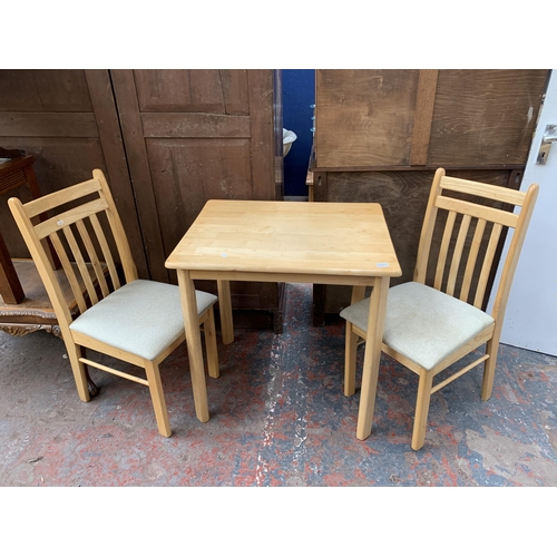 49 - A modern beech rectangular dining table and two chairs - approx. 75cm high x 60cm wide x 74cm long