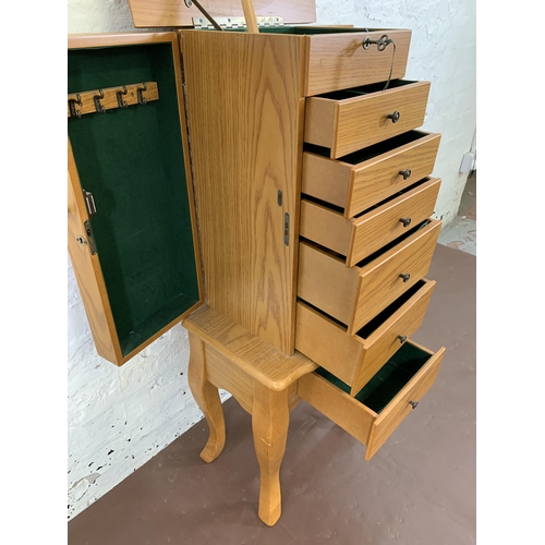 62 - A modern oak effect jewellery cabinet - approx. 98cm high x 40cm wide x 30cm deep