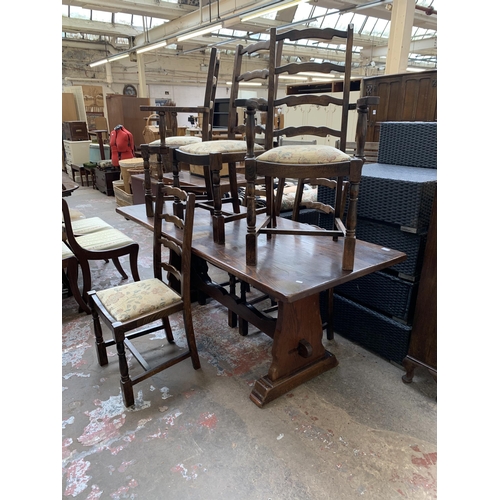 64 - An oak rectangular trestle dining table and six beech ladder back chairs - table approx. 83cm high x... 