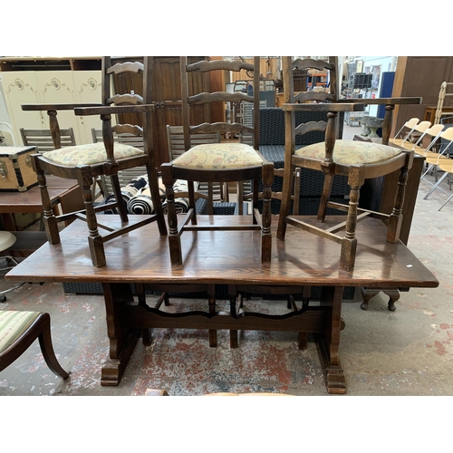 64 - An oak rectangular trestle dining table and six beech ladder back chairs - table approx. 83cm high x... 