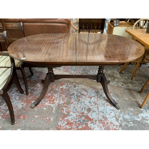 65A - A Georgian style mahogany twin pedestal extending dining table