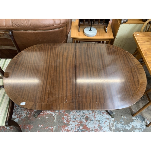 65A - A Georgian style mahogany twin pedestal extending dining table