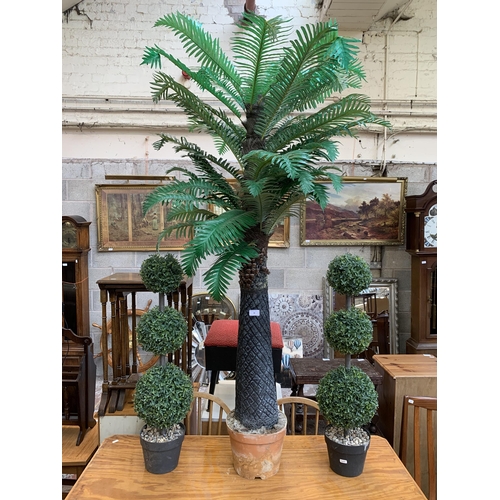 68 - Three artificial garden items, two plants and one palm tree