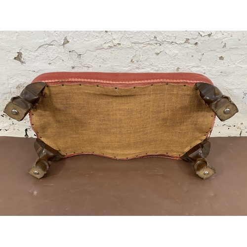 69 - A Georgian style pink fabric upholstered footstool on ball and claw supports