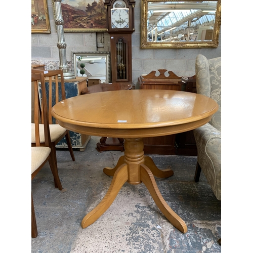 73 - A modern oak and beech circular pedestal dining table - approx. 74cm high x 100cm diameter